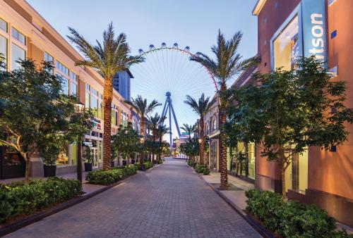 a city street with a ferris wheel in the background at The LINQ Hotel and Casino in Las Vegas