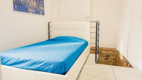 La Casa di Nonna Agnese - Italian Homing في بادينغي سول غاردا: غرفة نوم مع سرير مع لحاف أزرق