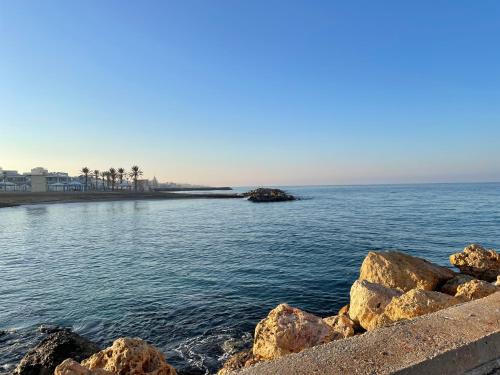 a view of a body of water with rocks at Breezot Yam in Nahariyya