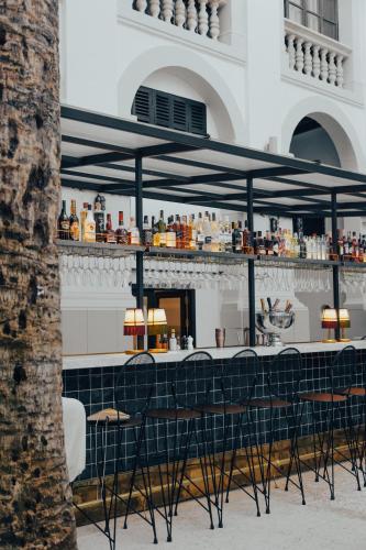 a bar with black chairs in front of a building at Hotel Born in Palma de Mallorca