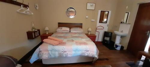 a bedroom with a large bed with pink pillows at Migdal Oz aka Rufpatch in Smithfield