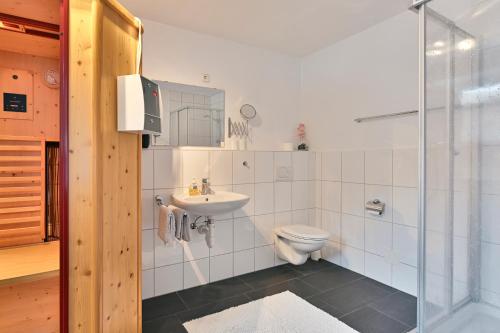 a bathroom with a toilet and a sink at Haus Flexen Appartements & Suite in Stuben am Arlberg