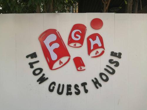 a sign for a restaurant with a sign for a guest room at Flow guest house in Chiang Mai