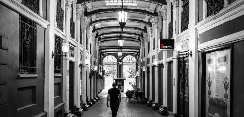 a man walking down a hallway in a building at Zrooms&Suites Hostel Boutique in Zaragoza