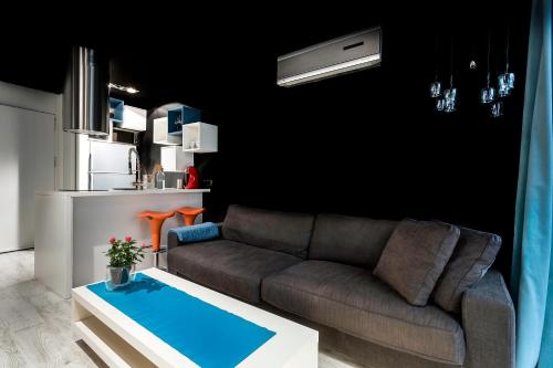 a living room with a couch and a kitchen at Zrooms&Suites Hostel Boutique in Zaragoza