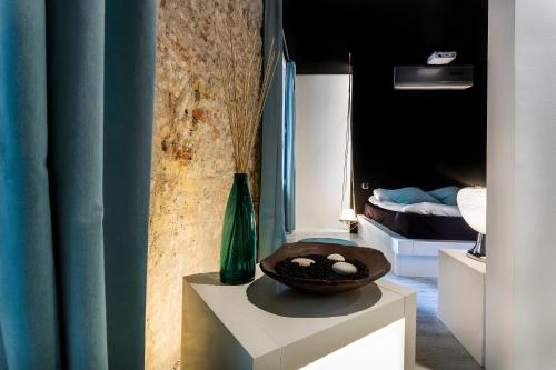 a room with a table with a bowl on it at Zrooms&Suites Hostel Boutique in Zaragoza