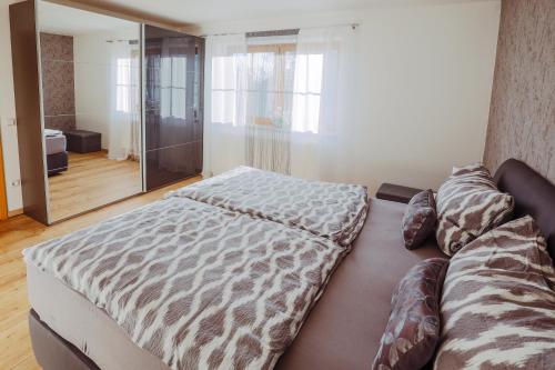 a bedroom with a bed and a large mirror at Ferienwohnung Gründlinger in Weilersbach