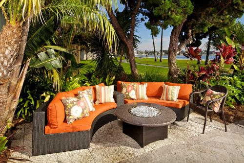 an outdoor patio with an orange couch and a table at Catamaran Resort Hotel and Spa in San Diego
