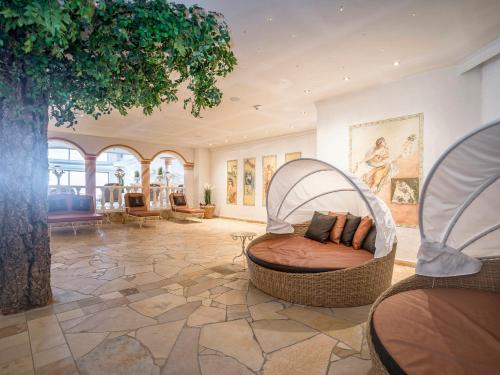 a room with a bed with a tree in it at Der Lärchenhof in Erpfendorf