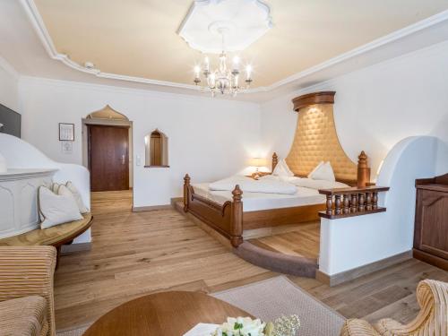 a bedroom with a bed and a living room at Der Lärchenhof in Erpfendorf
