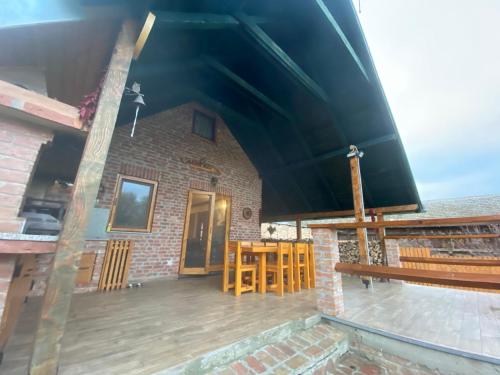 a house with a large roof with a patio at Kuća za odmor GUSKA in Kopačevo