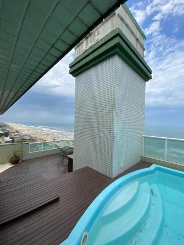 a hot tub on the deck of a building at Cobertura Beira Mar in Capão da Canoa