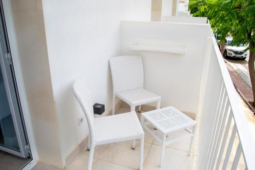 two chairs and a table on a balcony at INNER Hotel Rupit "Adults Only" in Cala d´Or