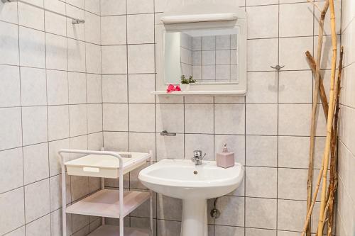 a white bathroom with a sink and a mirror at CrossRhodes Villas in Pefki