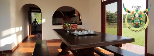 a dining room with a table and a view of a yard at Posada Hato el Diamante in San Luis de Palenque