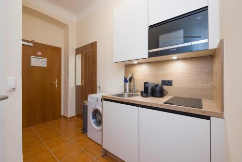 a kitchen with a sink and a washing machine at Vienna Stay Apartments Schönbrunn in Vienna