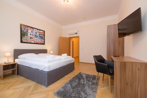 a bedroom with a bed and a flat screen tv at Vienna Stay Apartments Schönbrunn in Vienna