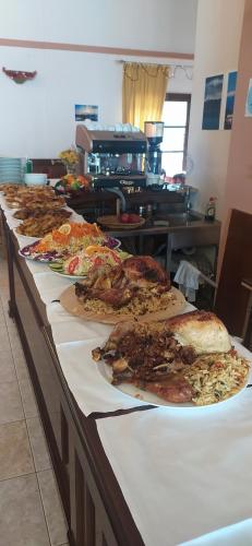 a buffet line with many different types of pizza at HOTEL ΗΩ (ΞΕΝΩΝΑΣ ΤΣΙΑΧΡΗΣ) in Morfovoúnion