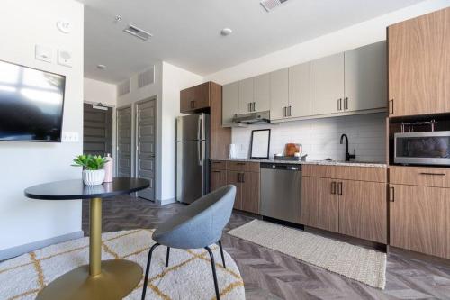a kitchen with a table and a chair in it at Yugo Guest Suites in Urbana