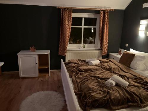 a bedroom with a large bed and a window at Berghotel Drei Brüder Höhe in Marienberg