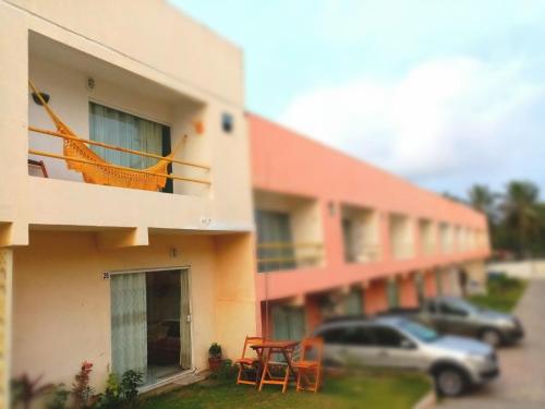 a building with a car parked in front of it at Casa Arembepe in Camaçari