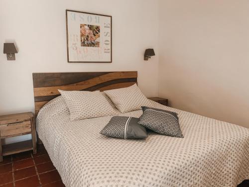 a bedroom with a bed with pillows on it at Mas Escombelle in Barjac