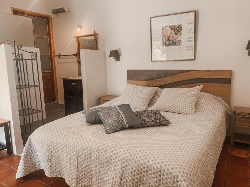 a bedroom with a bed with two pillows on it at Mas Escombelle in Barjac