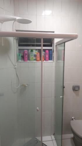 a bathroom with a glass shower stall with a toilet at Apartamento 3 quartos e 3 sacadas de frente para o mar com visão panorâmica de toda praia de Itapema in Itapema