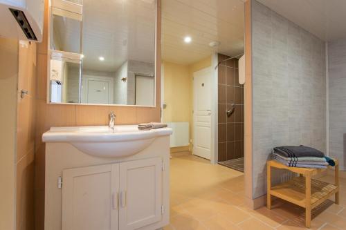 a bathroom with a white sink and a shower at Domaine Sur-Valot in Beaubery