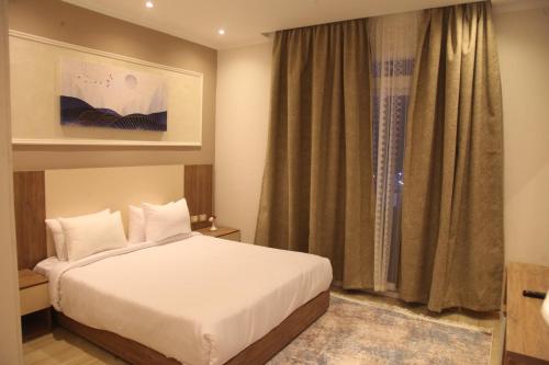 a hotel room with a bed and a window at Jewel Assiut Hotel in Asyut