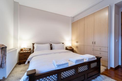 una camera da letto con un grande letto con asciugamani di The Foxes - Modern 1BD apartment in the Forest a Gávros
