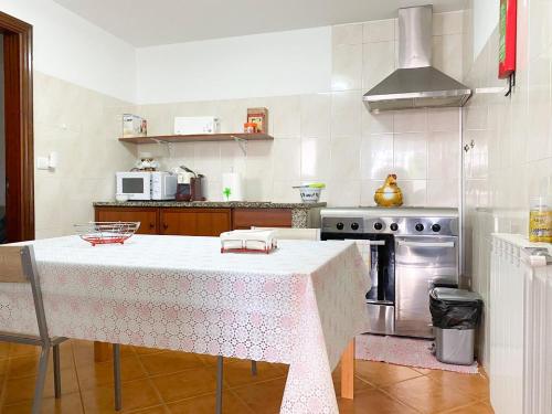 a kitchen with a table and a stove at House in Vila Nova de Cerveira with Pool and BBQ #1881 in Campos