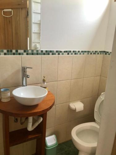 a bathroom with a sink and a toilet at Posada Agua Marina in La Paloma