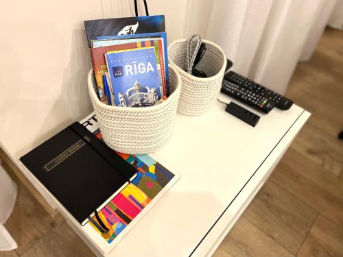 a white table with books and a keyboard and a keyboard at Cozy Home Jekaba Apartment, old town, self check-in in Rīga