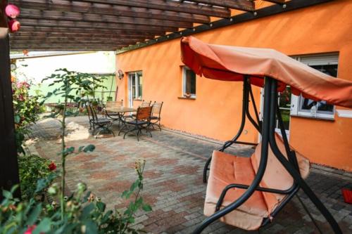 a patio with a table and chairs and an umbrella at Ferienhaus Spreewald Linde​ in Belten