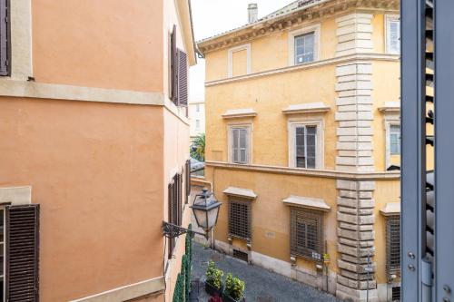 a view of an alley from a window at [PIAZZA DI SPAGNA 5 STELLE] Parlamento Room in Rome