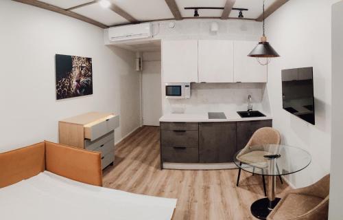 a kitchen with a counter and a table in a room at MyApartments Kotka in Tallinn