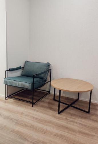 a chair and a coffee table in a room at MyApartments Kotka in Tallinn