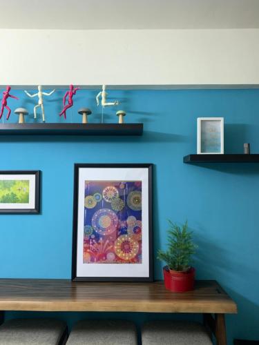 a blue wall with a picture on a wooden table at Duke 369 in Donggang