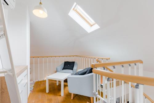 a baby room with a chair and stairs at Luxury Villa Roza in Split