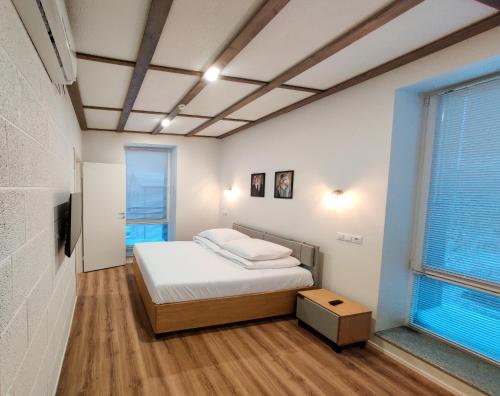 a small bedroom with a bed and a window at MyApartments Kotka in Tallinn
