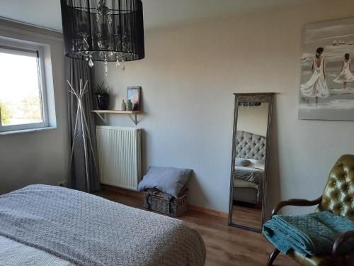 a bedroom with a bed and a mirror at Apartment Nathalie in Comines