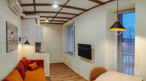 a living room with a couch and a window at MyApartments Kotka in Tallinn