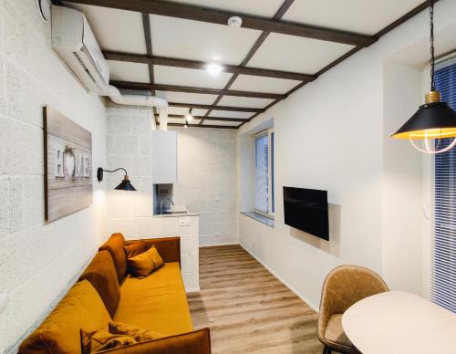 a living room with a couch and a tv at MyApartments Kotka in Tallinn