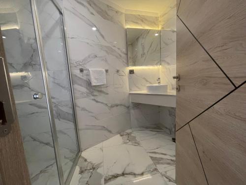 a bathroom with a shower and a sink at Le Luxe Suites Hotel & Spa in Bursa