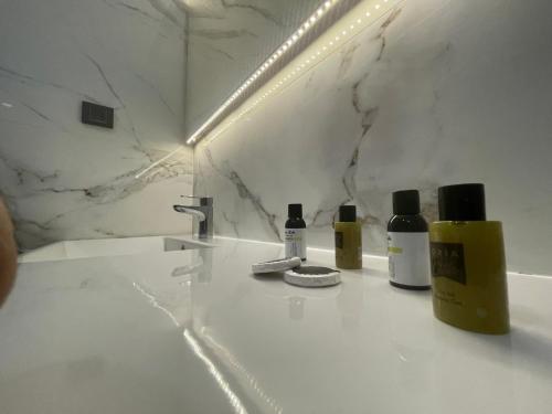 a bathroom with two bottles of soap and a sink at Le Luxe Suites Hotel & Spa in Bursa