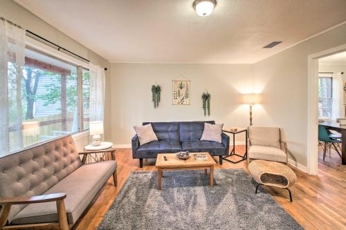 a living room with a couch and a table at Centrally Located Hot Springs Home with Deck! in Hot Springs