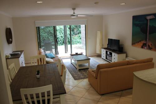 a living room with a couch and a table at Yackataya at Cowes in Cowes