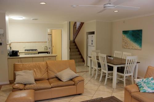 a living room with a couch and a table at Yackataya at Cowes in Cowes