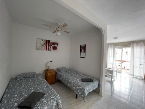 una camera con 2 letti e un ventilatore a soffitto di Apartaments Royale Los Cristianos ad Arona